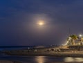 Sunset with the moon in the background reflected in the sea on the beach of Gandia, Valencia. Spain. Royalty Free Stock Photo