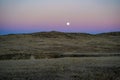 Sunset with moon and moonrise on the high desert plains