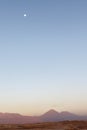 Sunset at the Moon Valley Valle de la Luna with the Licancabur volcano and the moon in the background, Atacama, Chile Royalty Free Stock Photo