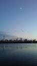 Sunset and Moonrise above Midtown and Upper West Side Buildings Seen from Central Park in Manhattan, New York, NY.