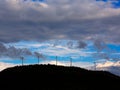 Sunset mountain with electric windmills Royalty Free Stock Photo