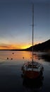 Sunset with mountain, lake and sail boat Royalty Free Stock Photo