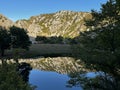 sunset mountain lake, soft ligh, mirroring like in glass mountain in water. Croatia, Krnjeza in Kanyon, in northern Dalmatia Royalty Free Stock Photo