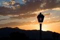 Sunset on the mountain with silhouette of classic lamppost Royalty Free Stock Photo