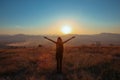 Sunset mountain. Tourist Free happy woman outstretched arms wit