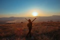 Sunset mountain. Tourist Free happy woman outstretched arms wit