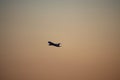 Sunset, mountains and flying plane