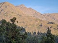 Sunset in the mountains with forests and clear skies.