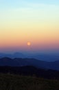 Sunset on the mountains in a full moon evening