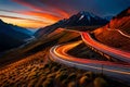 Sunset in the mountains with light trail of vehicles in the road Royalty Free Stock Photo