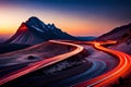 Sunset in the mountains with light trail of vehicles in the road Royalty Free Stock Photo