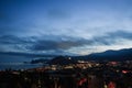 Sunset in the mountains near the Black Sea in Crimea, Novy Svet, summer, Genoese fortress, night city in lights. Royalty Free Stock Photo