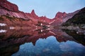 Sunset in mountains near lake. Sunlight reflected on mountain tops. Golden light from sky reflected in a mountain lake. Ergaki. Royalty Free Stock Photo