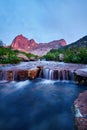 Sunset in mountains near river. Sunlight reflected on mountain tops. Golden light from sky reflected in a mountain river. Ergaki.