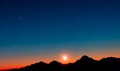 Sunset with mountains in silhouette