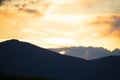 Sunset in the mountains. Silhouettes of fir trees on a mountainside in the sunset light. Royalty Free Stock Photo