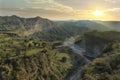 Sunset through mountains and valley.