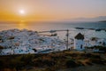 Sunset Mykonos Greece , colorful streets of the old town of Mykonos with tourist in the street Royalty Free Stock Photo