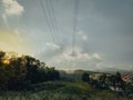 Sunset near the Electricity pylon with rainforest tropical trees near the housing area in Malaysia Royalty Free Stock Photo