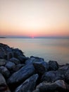 Sunset at Neoi Epivates, suburb of Thessaloniki, Greece. View of rocks and sea. Royalty Free Stock Photo