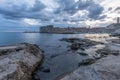 Sunset and Night view of Dubrovnik old town from seaside with reefs in foreground, Croatia Royalty Free Stock Photo
