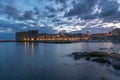 Sunset and Night view of Dubrovnik old town from seaside with reefs in foreground, Croatia Royalty Free Stock Photo