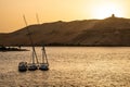 Sunset Nile Aswan and the West Bank with Tombs Old Kingdom Qubbet el-Hawa - `Dome of the Winds` at the crest of the hill Royalty Free Stock Photo