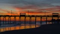 Colorful Sunset at ocean coast with silhouette of pier and photo Royalty Free Stock Photo