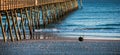 Colorful Sunset at ocean coast with silhouette of pier and photo Royalty Free Stock Photo