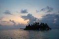 Sunset, ocean and coconut trees near paradisiac island Royalty Free Stock Photo