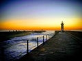 Sunset at the ocean pier with a lighthouse, Porto, Portugal, January 2019 Royalty Free Stock Photo