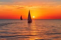 Sunset on the ocean with sailing yachts on the horizon Royalty Free Stock Photo