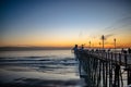 Sunset by Oceanside Pier, Palms and the Pacific Oceanin the famous surf city in California USA