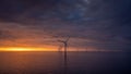 Sunset offshore at wind turbine farm Royalty Free Stock Photo