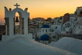 Sunset in Oia village on Santorini, Greece. Famous Santorini sunset capture. Blue dome churches in the background. Royalty Free Stock Photo