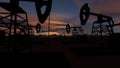 The silhouette of oil pumps in a large oil field at sunrise. 3d rendering. 3d illustration Royalty Free Stock Photo