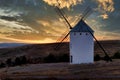 Sunset of old spanish windmills on a sunny day with clouds Royalty Free Stock Photo