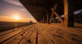 Sunset at an old train station with wooden platform and railway tracks Royalty Free Stock Photo