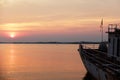 Sunset and old warship at estuary