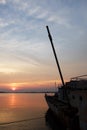 Sunset and old warship at estuary