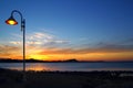 Sunset orange blue seascape light lamppost Royalty Free Stock Photo