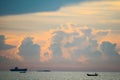 sunset orange cloud back on dark silhouette sky and fishing boat on sea Royalty Free Stock Photo