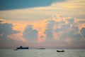 sunset orange cloud back on dark silhouette sky and fishing boat on sea Royalty Free Stock Photo