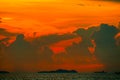 sunset orange cloud back on dark silhouette sky and fishing boat on sea Royalty Free Stock Photo