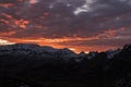 Sunset with orange clouds over snowy mountains of the Cantabrian mountains Royalty Free Stock Photo