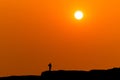 The sunset and orange gold scene small people on mountain foreground