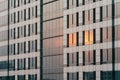 Sunset orange light reflected on glass and cladding facade in the evening Royalty Free Stock Photo