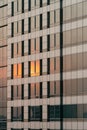 Sunset orange light reflected on glass and cladding facade in the evening Royalty Free Stock Photo