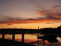 A Sunset of orange over the docks on Goose Creek