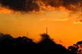 Sunset orange with rain clouds and mountain.